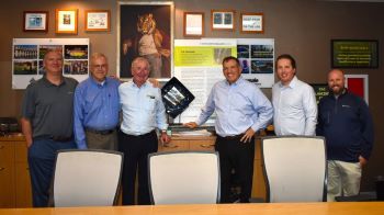 Six SAC employees posing for a picture in their conference room